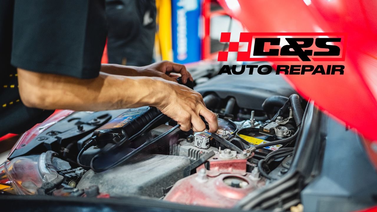 Mechanic inspecting car electrical system during winter in Edmonton